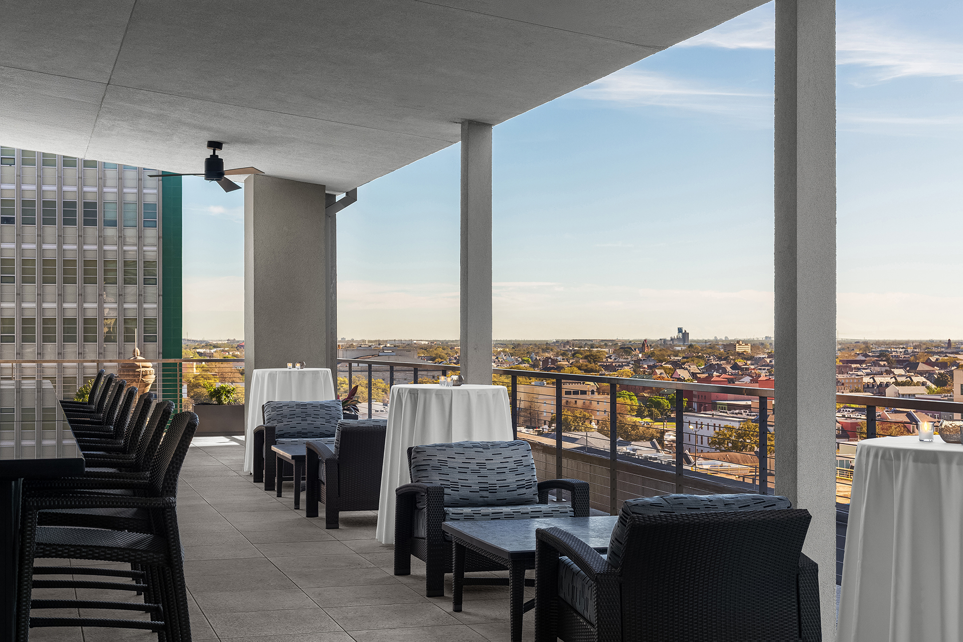 A covered outdoor bar with a view of the city