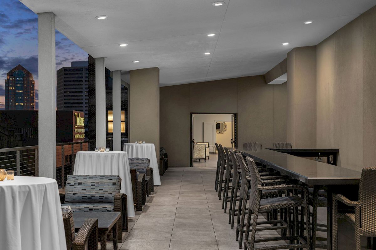 a bar with tables and chairs on a balcony