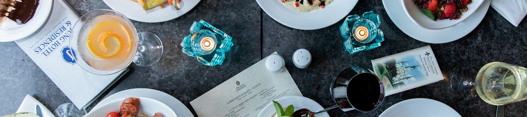 Overhead view of New Orleans dishes served at The Jung Hotel & Residences